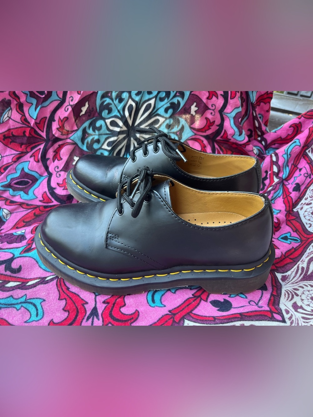 Black leather Dr. Martens oxfords with yellow stitching